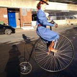 Curious Sitwells - Astride a full sized penny farthing bikes - Walkabout 